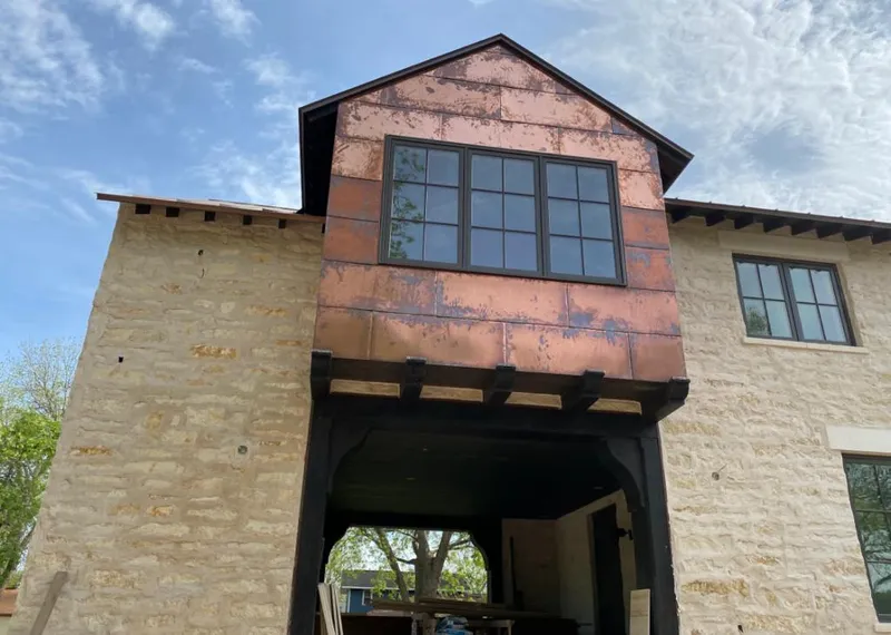 Copper metal panel facade on a stone building for Skylight Installation in Cazenovia